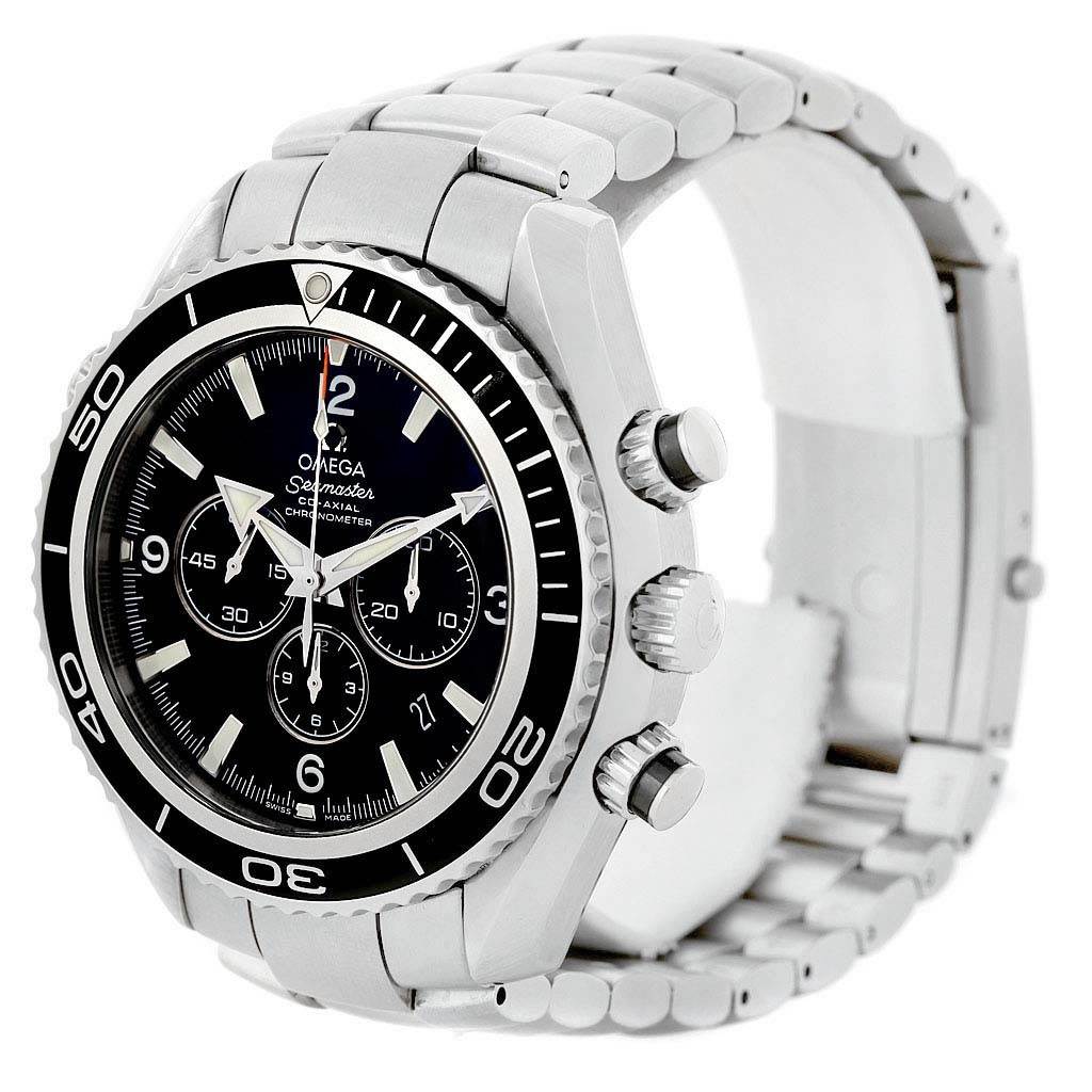 The image shows the Omega Planet Ocean 2210.50.00 Men's Stainless Steel Black Dial 2210.50.00 Men's Stainless Steel Black Dial watch at an angled side view, highlighting its dial, bezel, crown, pushers, and metal bracelet.