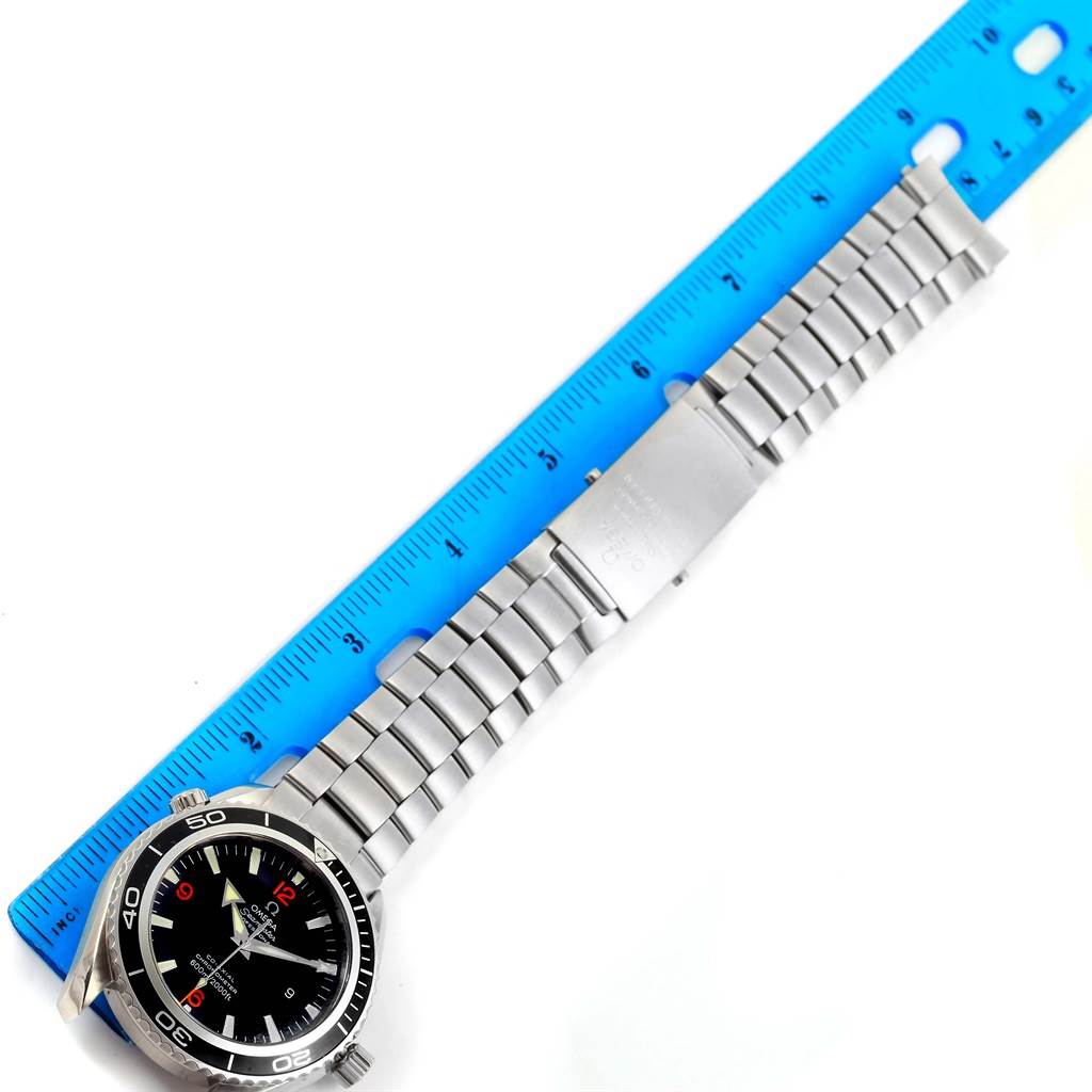 The Omega Planet Ocean 2200.51.00 Men
s Stainless Steel Black Dial 2200.51.00 Men
s Stainless Steel Black Dial watch is shown laid flat, alongside a ruler measuring its stainless steel bracelet.