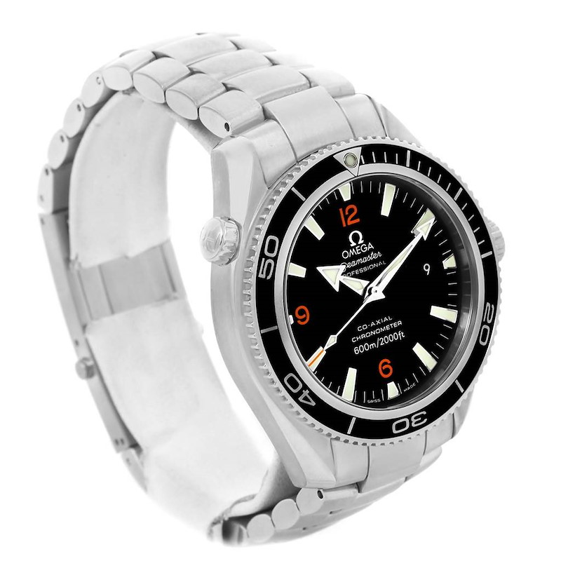 The image shows an angled view of the Omega Planet Ocean watch, highlighting the bracelet, bezel, and face with markers.