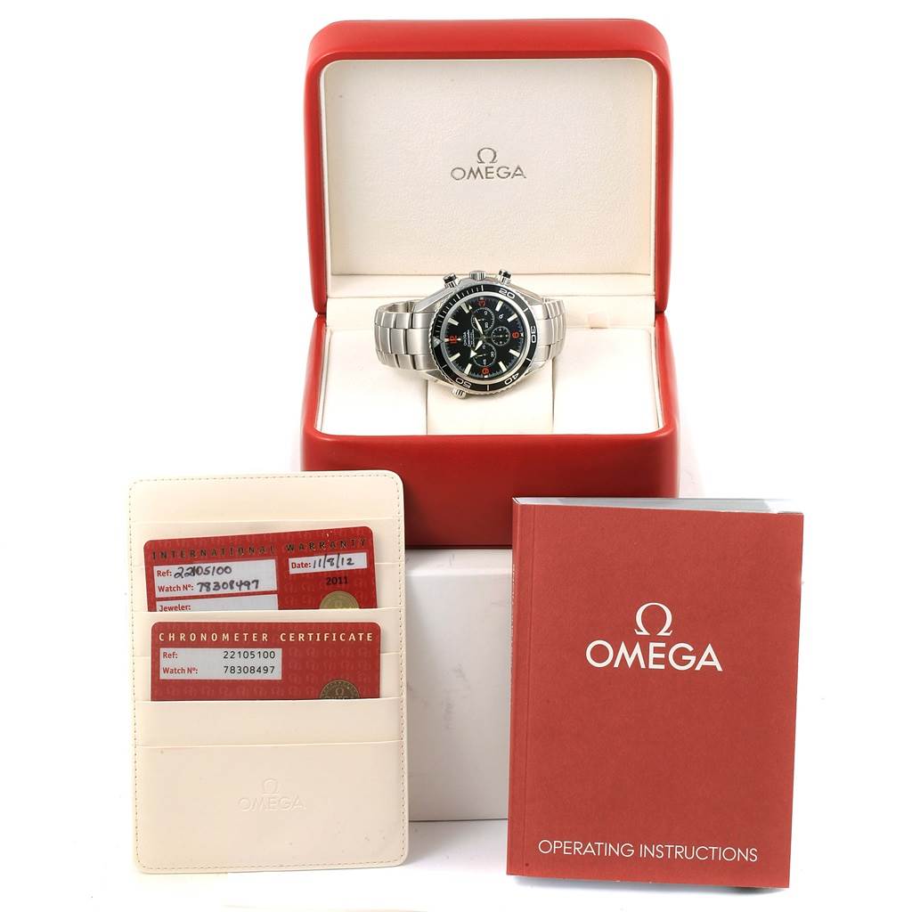 The Omega Planet Ocean 2210.51.00 Men's Stainless Steel Black Dial 2210.51.00 Men's Stainless Steel Black Dial watch is shown in its box, accompanied by warranty cards and the operating instructions.