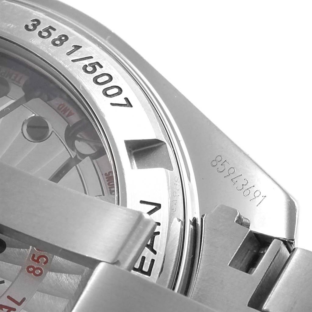 The image shows a close-up of the Omega Planet Ocean 232.30.42.21.01.004 Men's Stainless Steel Black Dial 232.30.42.21.01.004 Men's Stainless Steel Black Dial watch, highlighting its serial number and part of its case back.