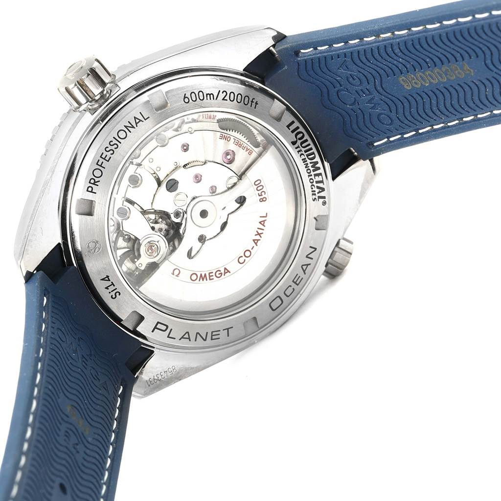 The image shows the back of the Omega Planet Ocean 232.92.42.21.03.001 Men's Titanium Blue Dial 232.92.42.21.03.001 Men's Titanium Blue Dial watch, highlighting its movement and the attached blue rubber strap.