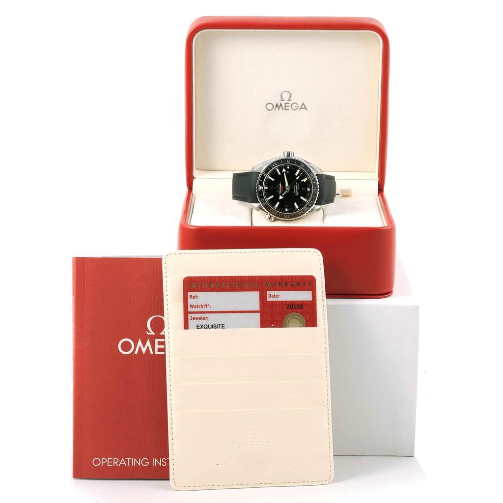 The Omega Planet Ocean 232.32.44.22.01.001 Men's Stainless Steel Black Dial 232.32.44.22.01.001 Men's Stainless Steel Black Dial watch is displayed in its box with operating instructions and a warranty card shown in front.