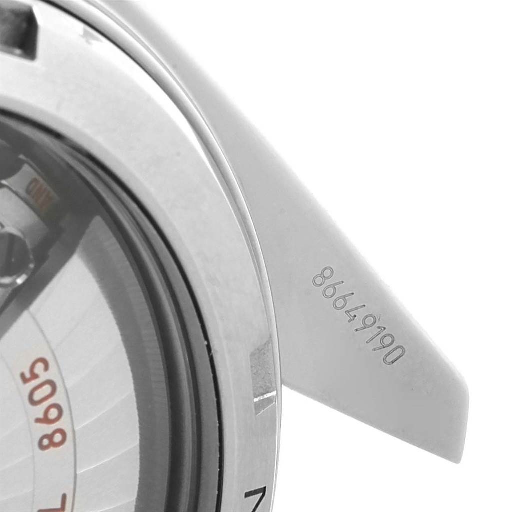 This image shows a close-up of the case back and serial number on the Omega Planet Ocean 232.32.44.22.01.001 Men's Stainless Steel Black Dial 232.32.44.22.01.001 Men's Stainless Steel Black Dial watch.