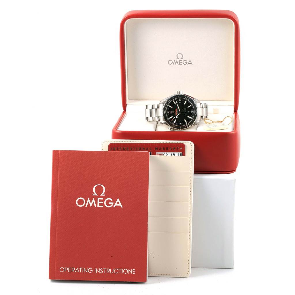 The image shows an Omega Planet Ocean 232.30.42.21.01.001 Men's Stainless Steel Black Dial 232.30.42.21.01.001 Men's Stainless Steel Black Dial watch in its box, along with operating instructions and a warranty card holder.