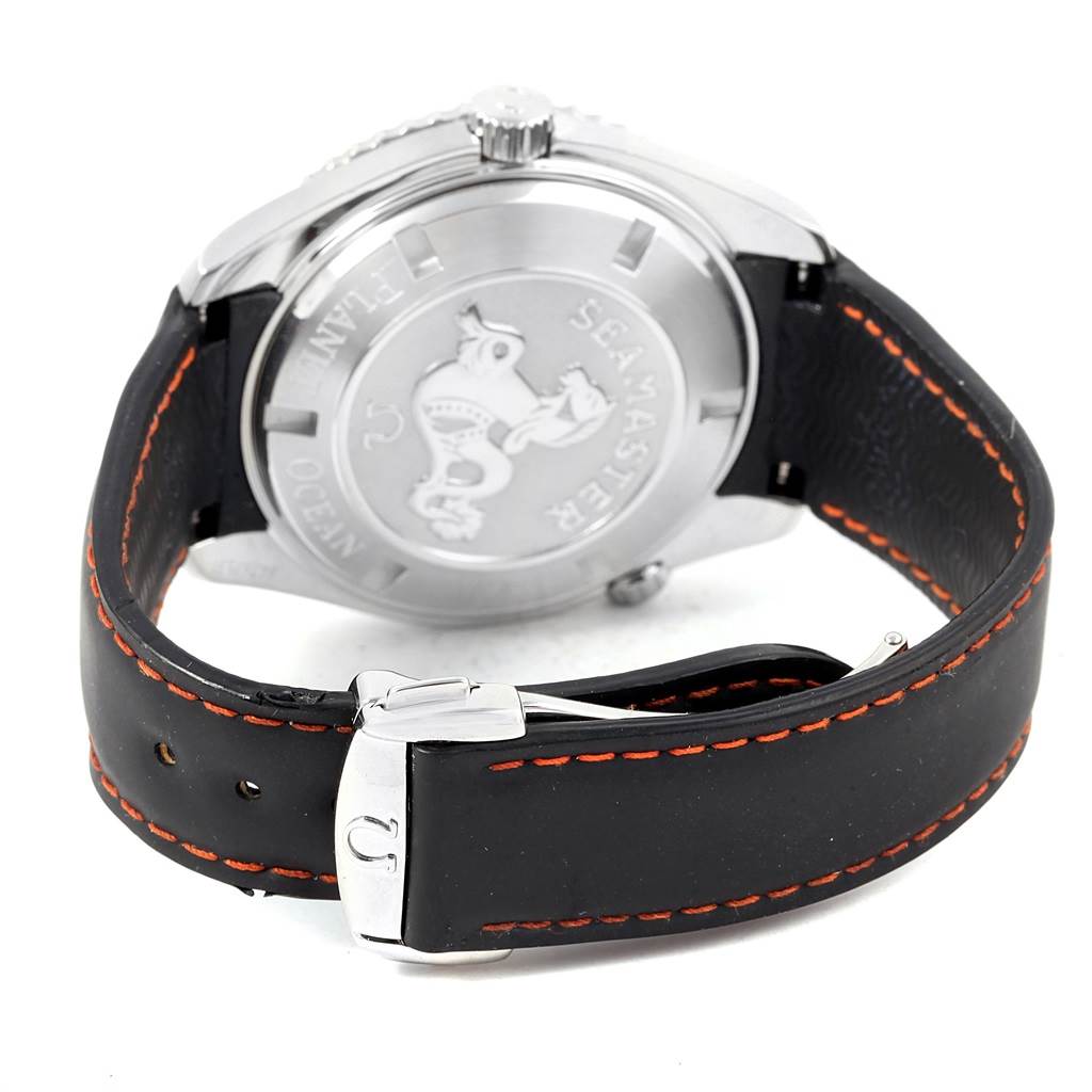 The image shows the back of an Omega Seamaster Planet Ocean watch, focusing on the case back and leather strap with orange stitching.
