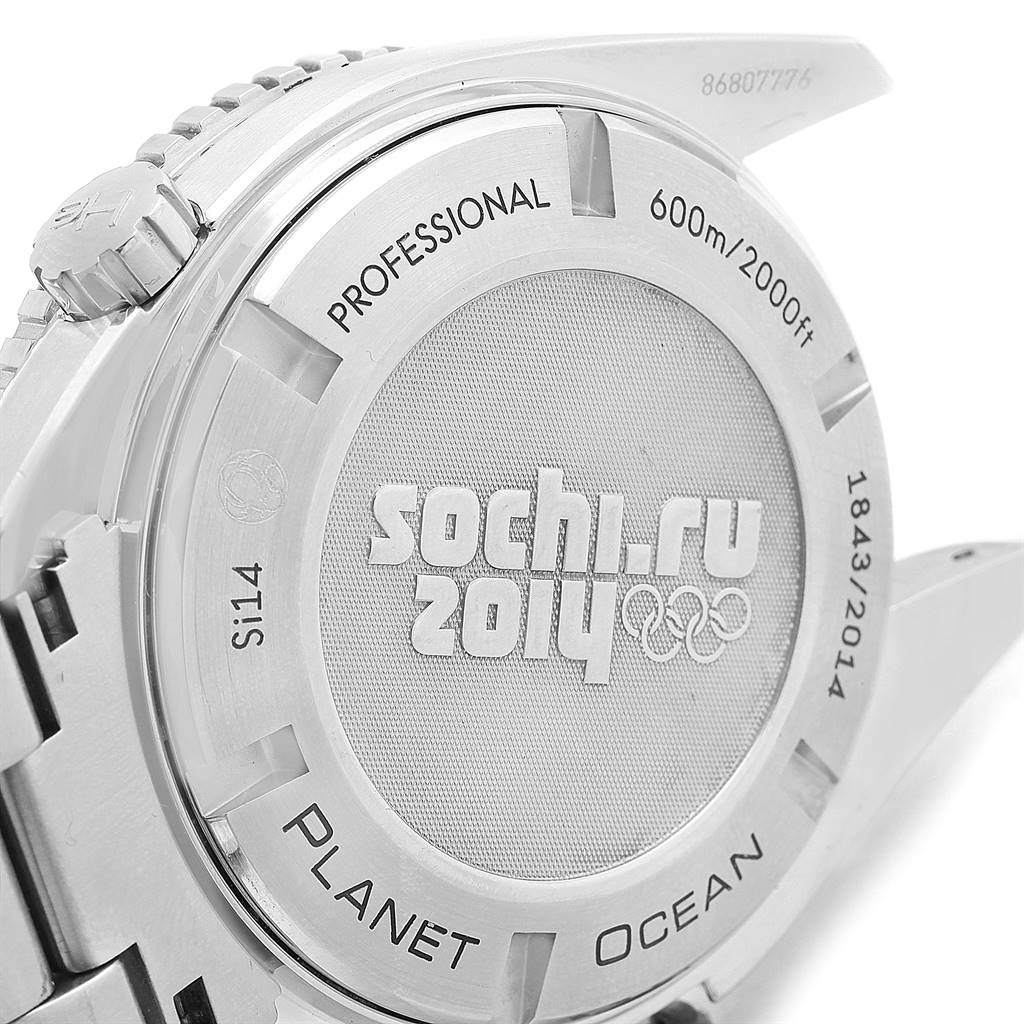 The image shows the case back of the Omega Planet Ocean 522.30.46.21.01.001 Men
s Stainless Steel Black Dial 522.30.46.21.01.001 Men
s Stainless Steel Black Dial watch with "Sochi 2014" engraving, crown, and partial bracelet.