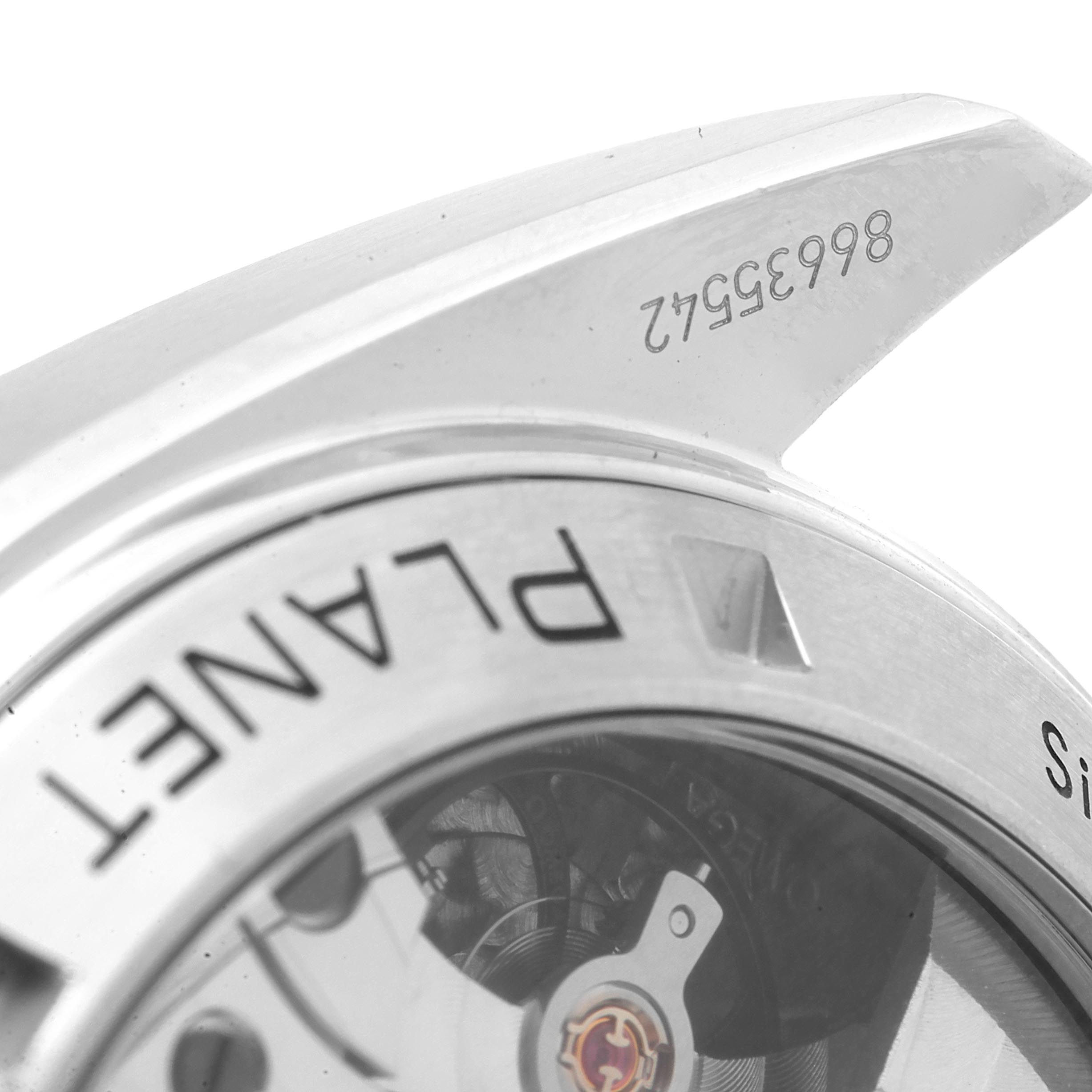 The image shows a close-up of the case back and the inner movement of an Omega Planet Ocean 232.30.46.51.01.001 Men
s Stainless Steel Black Dial 232.30.46.51.01.001 Men
s Stainless Steel Black Dial watch, including part of the serial number.