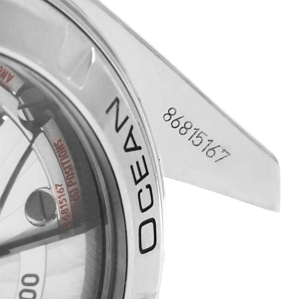 The image shows a close-up of the Omega Planet Ocean 232.30.42.21.01.001 Men's Stainless Steel Black Dial 232.30.42.21.01.001 Men's Stainless Steel Black Dial watch case and part of the serial number on a lug.