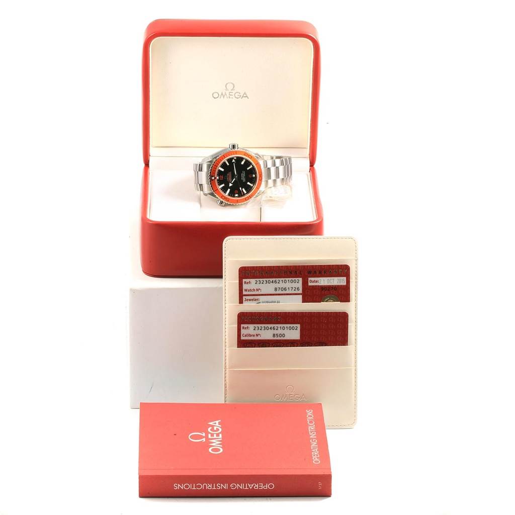 The image shows an Omega Planet Ocean 232.30.46.21.01.002 Men's Stainless Steel Black Dial 232.30.46.21.01.002 Men's Stainless Steel Black Dial watch in its open box, with warranty cards and an instruction booklet displayed in front.