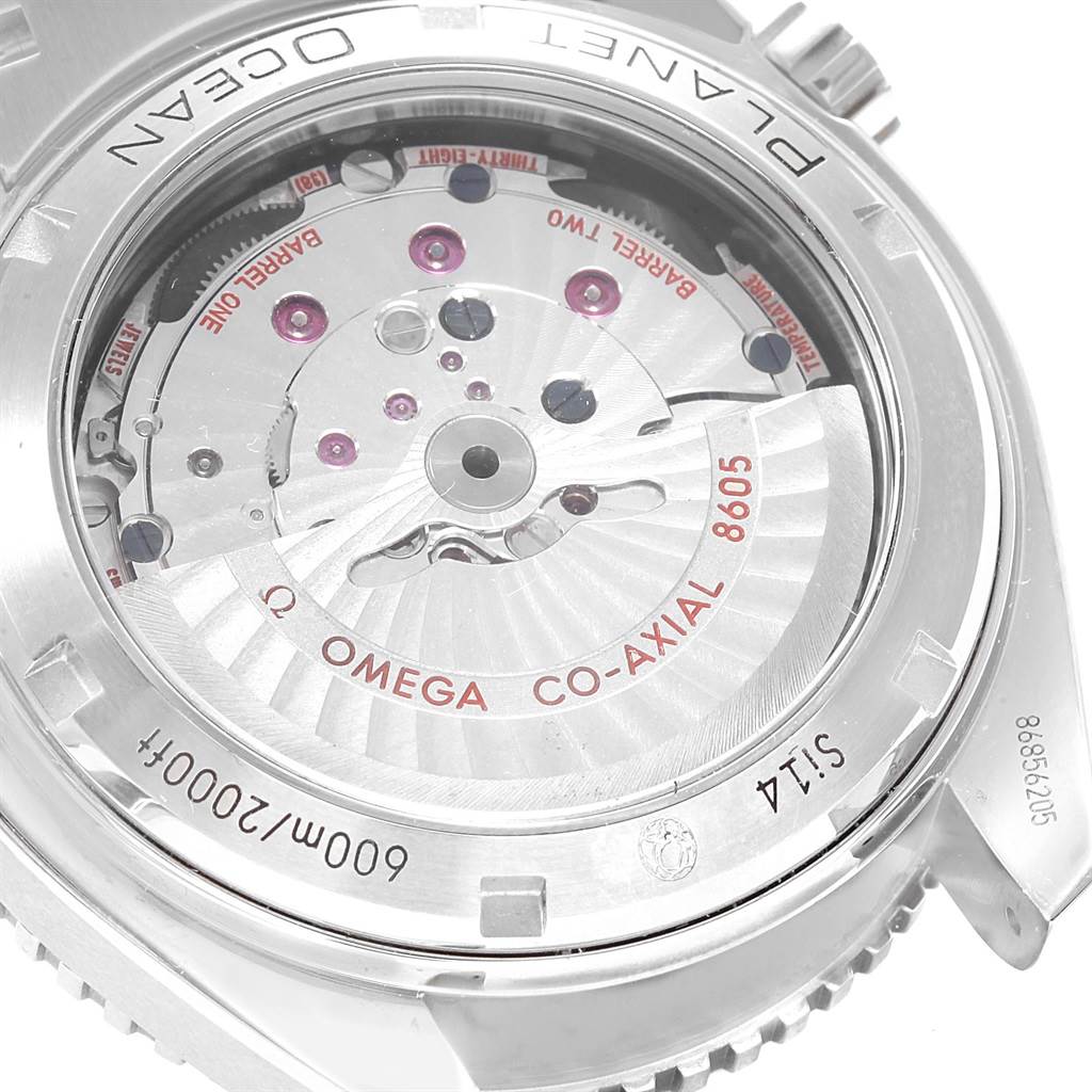 The image shows the back angle of an Omega Planet Ocean 232.30.44.22.01.001 Men
s Stainless Steel Black Dial 232.30.44.22.01.001 Men
s Stainless Steel Black Dial watch, highlighting the internal movement with "8605" and "Co-Axial" inscriptions.