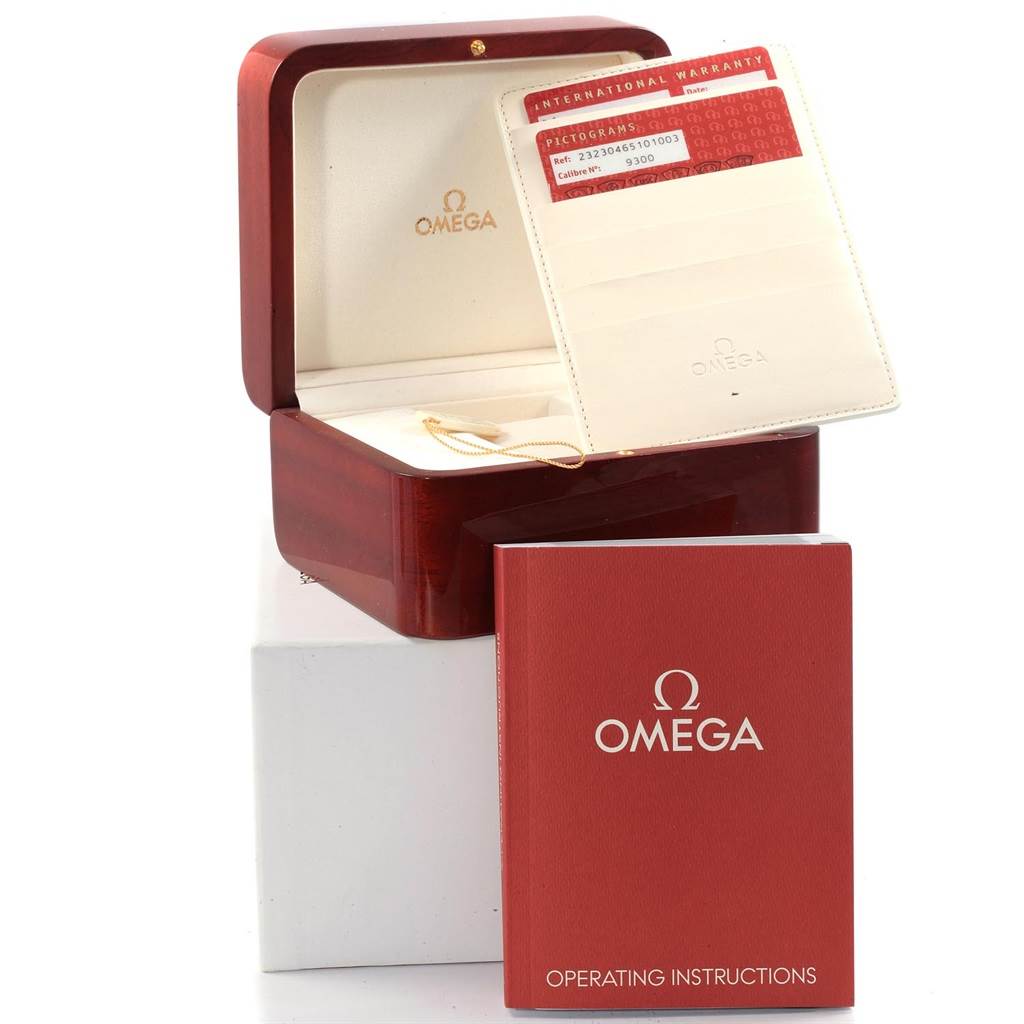 The image shows the open box, international warranty card, and operating instructions for the Omega Planet Ocean 232.30.46.51.01.003 Men
s Stainless Steel Black Dial 232.30.46.51.01.003 Men
s Stainless Steel Black Dial watch.