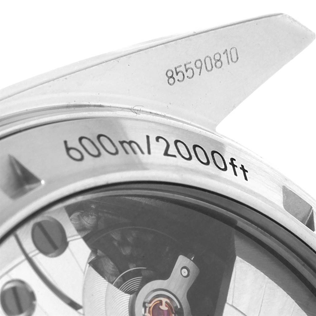 The image shows a close-up of the Omega Planet Ocean 232.30.46.51.01.003 Men
s Stainless Steel Black Dial 232.30.46.51.01.003 Men
s Stainless Steel Black Dial model
s case back, with visible depth rating and partial view of the movement.