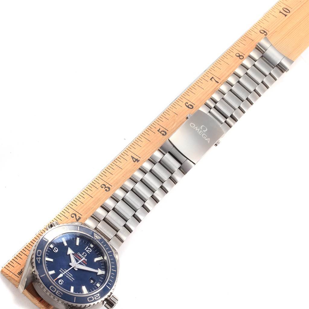 The image shows the Omega Planet Ocean 232.90.46.21.03.001 Men's Titanium Blue Dial 232.90.46.21.03.001 Men's Titanium Blue Dial watch laid flat, with its dial, bracelet, and clasp visible, measured against a ruler.