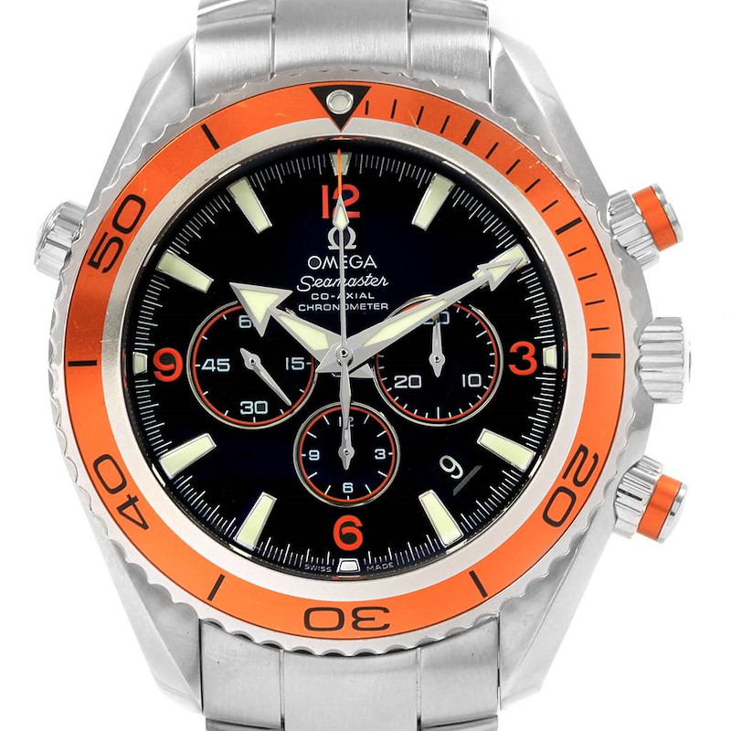 The image shows a front view of the Omega Planet Ocean model watch, highlighting its orange bezel, black dial, and chronograph features.