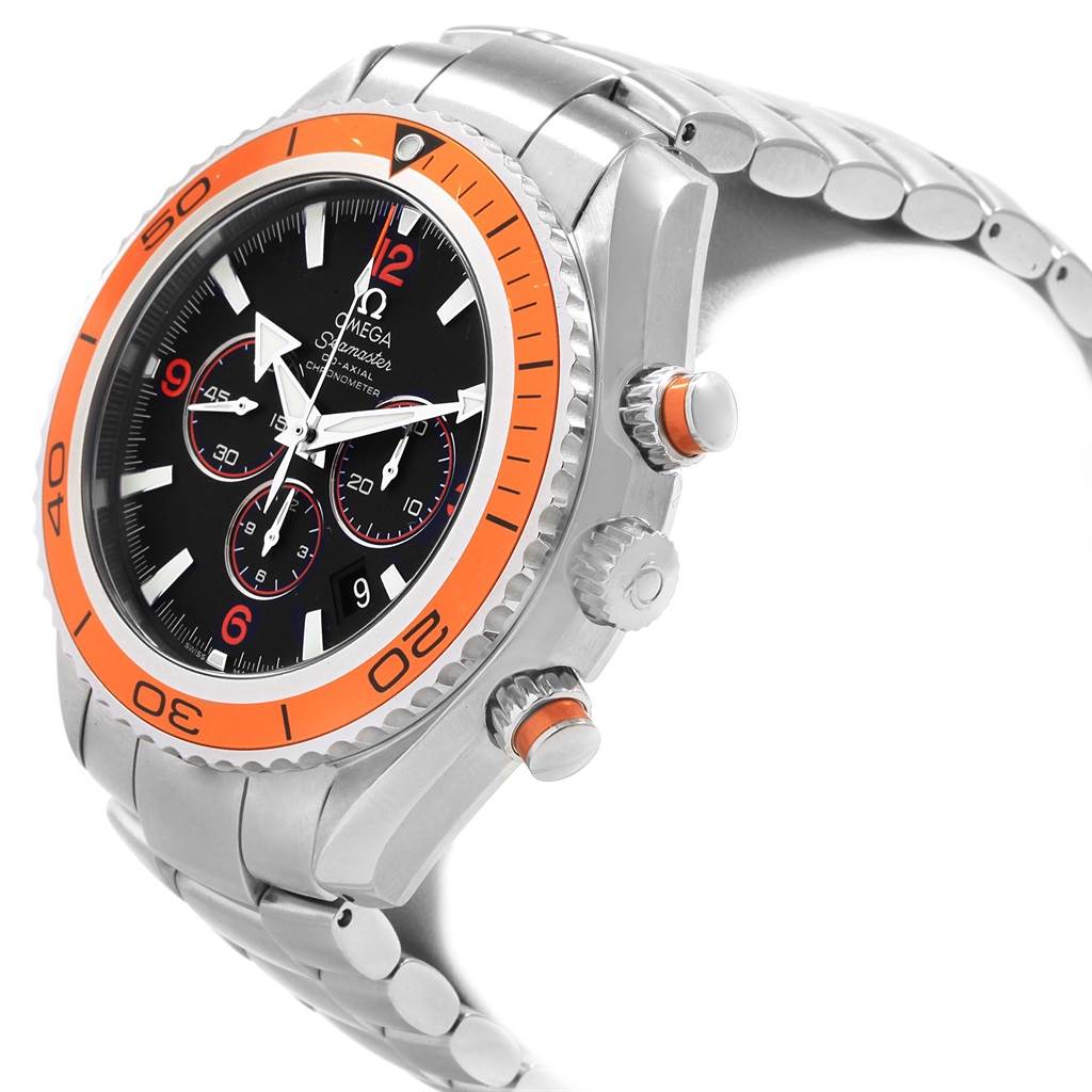 The image shows a side view of the Omega Planet Ocean 2218.50.00 Men
s Stainless Steel Black Dial 2218.50.00 Men
s Stainless Steel Black Dial watch, highlighting its orange bezel, black dial, and metal bracelet.