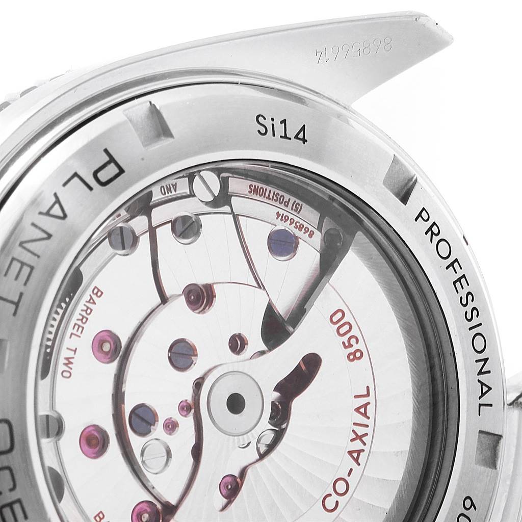 The image shows the back of an Omega Planet Ocean 232.30.46.21.01.002 Men
s Stainless Steel Black Dial 232.30.46.21.01.002 Men
s Stainless Steel Black Dial watch, highlighting its internal movement and co-axial mechanism. 