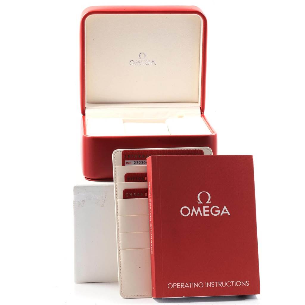 The image shows the accessories of the Omega Planet Ocean 232.30.42.21.01.001 Men
s Stainless Steel Black Dial 232.30.42.21.01.001 Men
s Stainless Steel Black Dial watch, including a red box, operating instructions, and warranty cards.