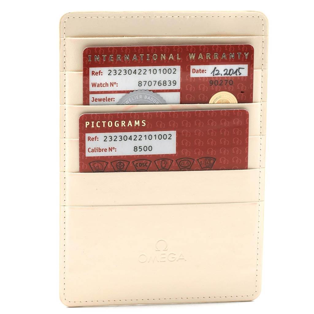 The image shows the warranty and pictogram cards for an Omega Planet Ocean 232.30.42.21.01.002 Men
s Stainless Steel Black Dial 232.30.42.21.01.002 Men
s Stainless Steel Black Dial watch, placed in a cream cardholder.