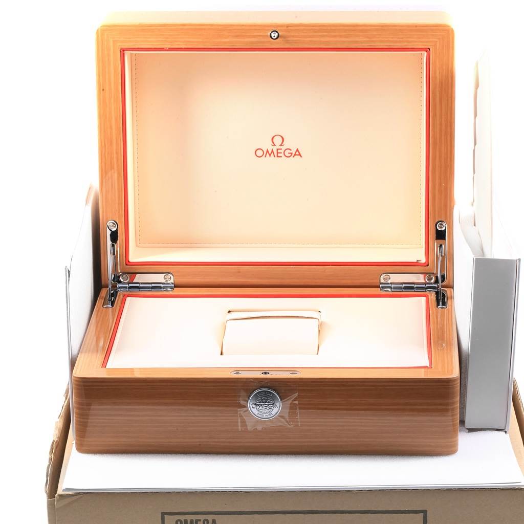 The image shows an open wooden Omega box for the Planet Ocean model, displaying its interior and hinged lid.