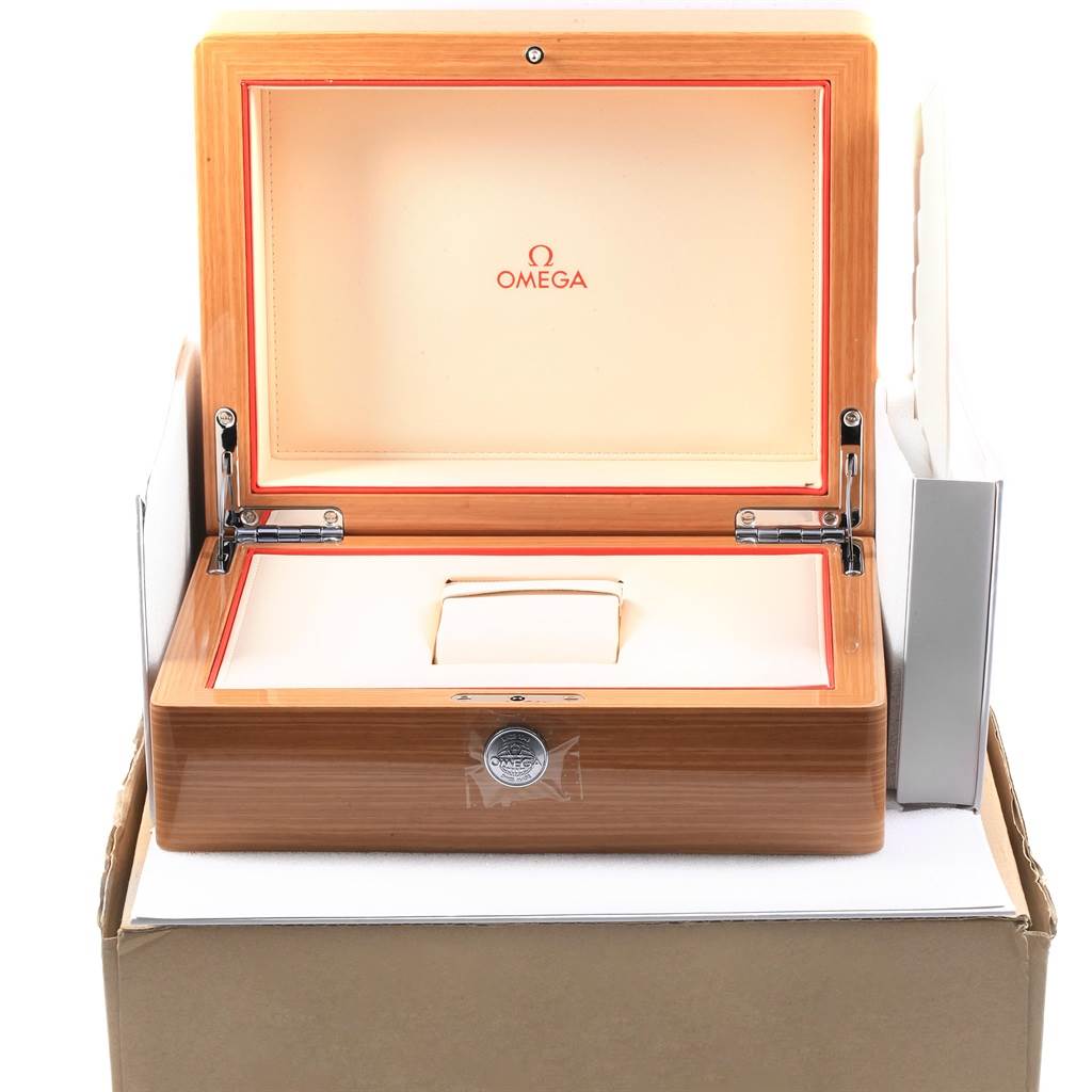 The image shows an open wooden Omega presentation box, likely for the Planet Ocean model.