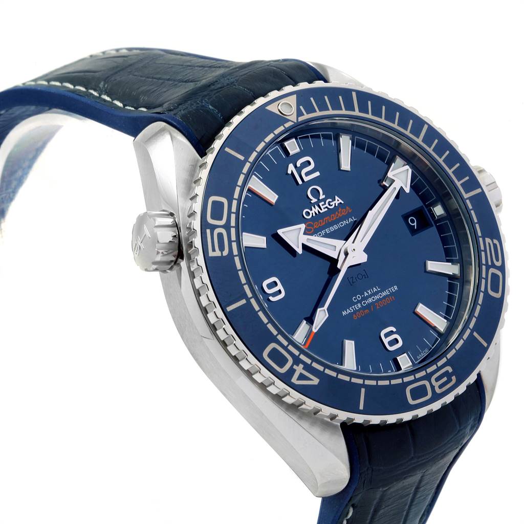 The image shows a side angle of the Omega Seamaster Planet Ocean watch, highlighting its blue dial, bezel, and strap.