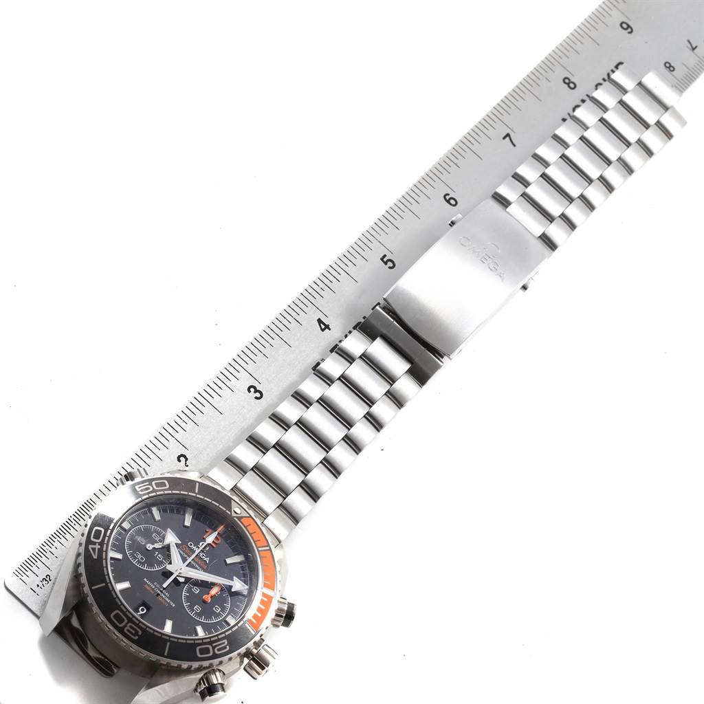 The image shows the Omega Planet Ocean 215.30.46.51.01.002 Men's Stainless Steel Black Dial 215.30.46.51.01.002 Men's Stainless Steel Black Dial watch flat with its metal bracelet and clasp displayed against a ruler.