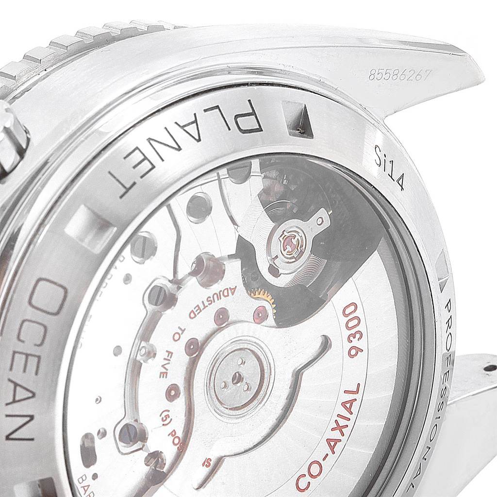 The image shows the back of the Omega Planet Ocean 232.30.46.51.01.003 Men's Stainless Steel Black Dial 232.30.46.51.01.003 Men's Stainless Steel Black Dial watch, highlighting its inner mechanical parts and engravings.