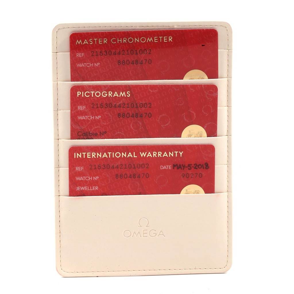 The image displays three Omega warranty and chronometer cards for the Planet Ocean model in a white cardholder.