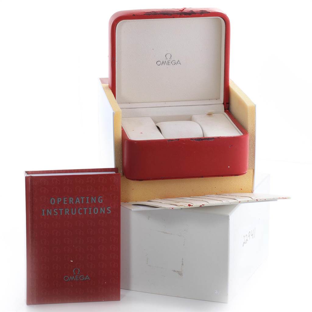 The image shows the box, tissue paper, and operating instructions for the Omega Planet Ocean 232.30.44.22.01.001 Men
s Stainless Steel Black Dial 232.30.44.22.01.001 Men
s Stainless Steel Black Dial watch model.