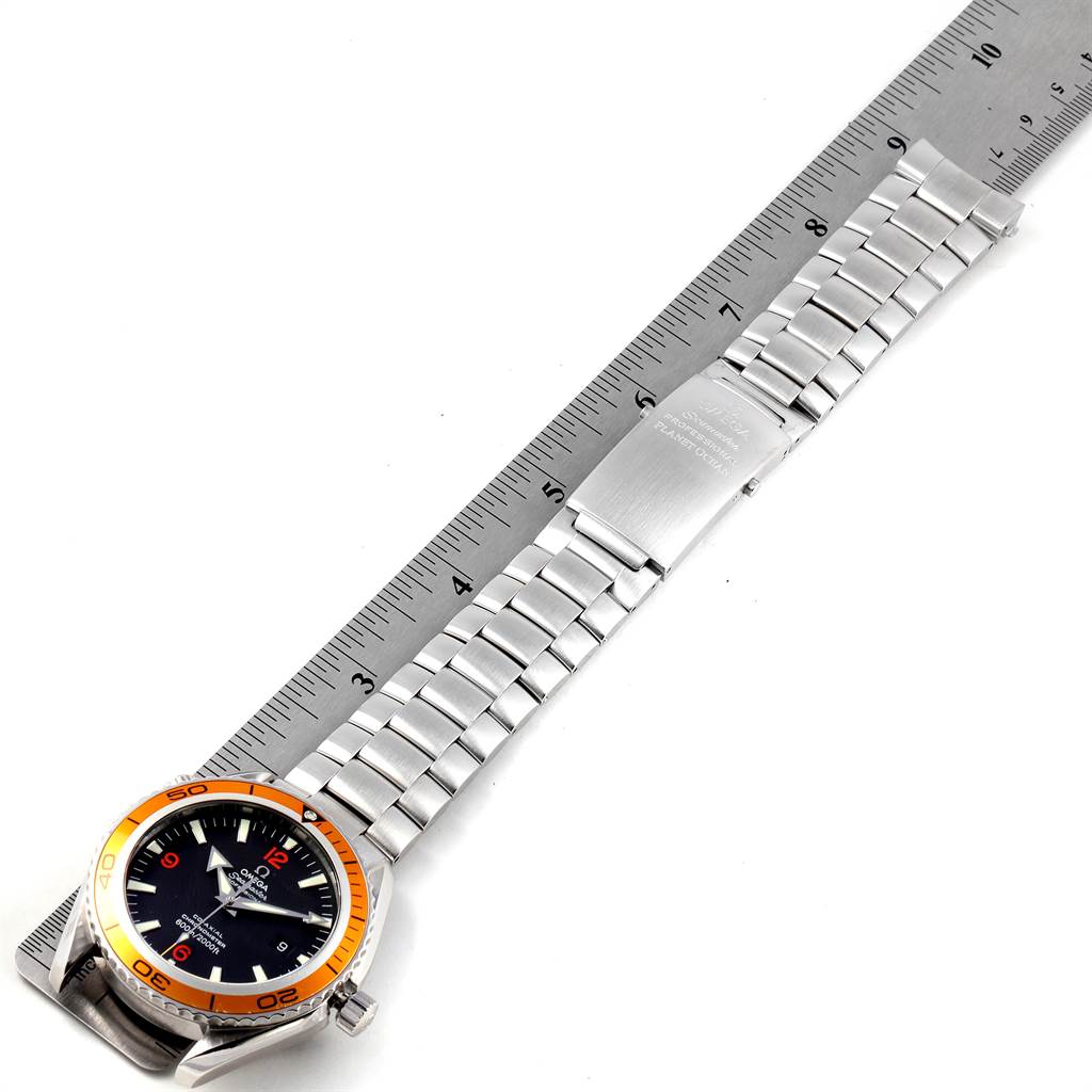 The image shows an Omega Planet Ocean 2208.50.00 Men
s Stainless Steel Black Dial 2208.50.00 Men
s Stainless Steel Black Dial watch from a top-down angle, displaying the dial, bezel, and metal bracelet alongside a ruler for scale.