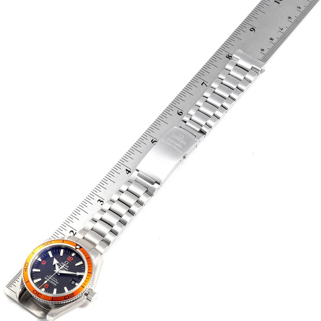 The Omega Planet Ocean 2209.50.00 Men
s Stainless Steel Black Dial 2209.50.00 Men
s Stainless Steel Black Dial watch is displayed flat with the dial at an angle, showing the bracelet and the face alongside a ruler.