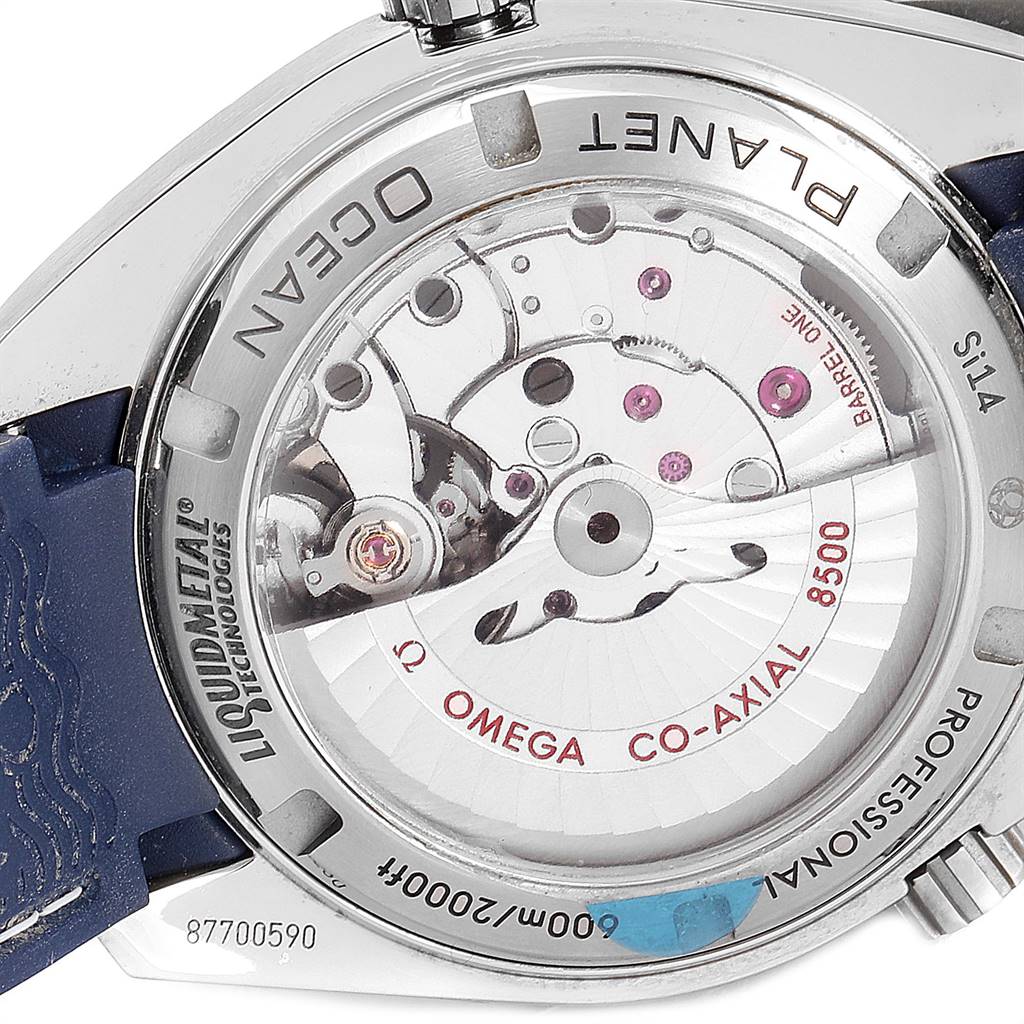 The image shows the back view of the Omega Planet Ocean 232.92.42.21.03.001 Men
s Titanium Blue Dial 232.92.42.21.03.001 Men
s Titanium Blue Dial watch, highlighting its Co-Axial 8500 movement and Liquidmetal® technology.