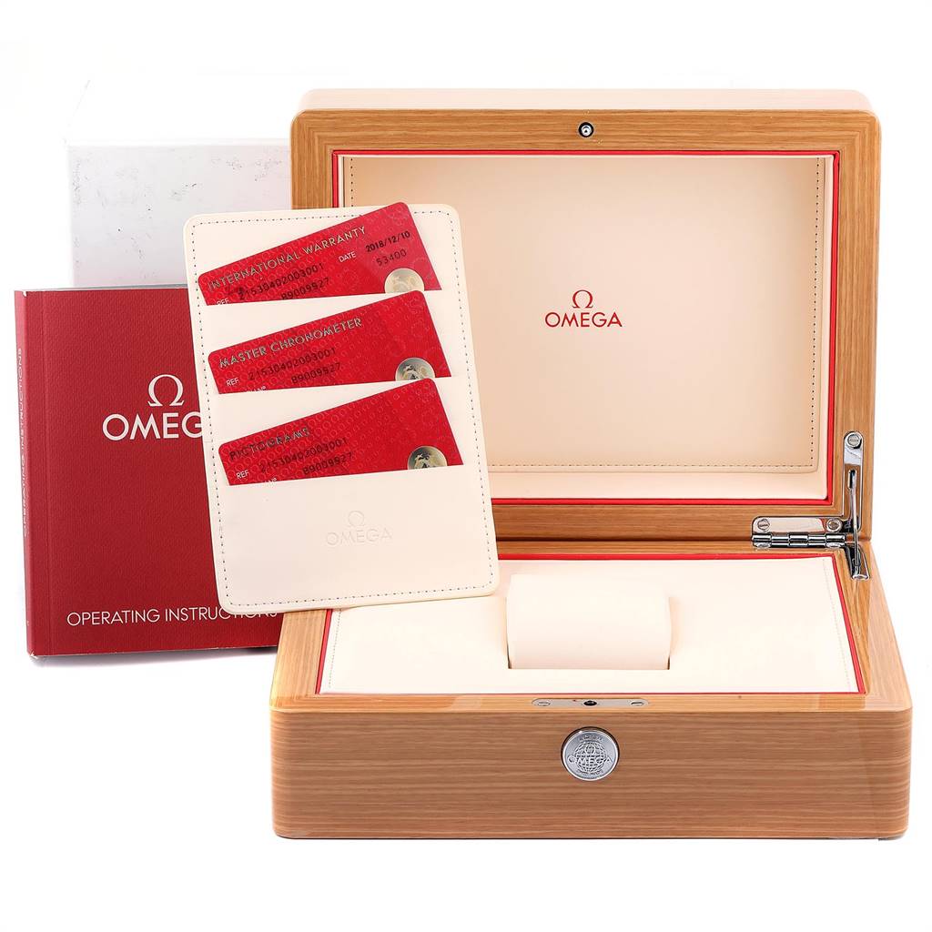 The image shows an open Omega Planet Ocean 215.30.40.20.03.001 Men
s Stainless Steel Blue Dial 215.30.40.20.03.001 Men
s Stainless Steel Blue Dial watch box, instructional manuals, and warranty cards.