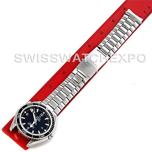 This image shows the full length of an Omega Planet Ocean 2200.50 Men's Stainless Steel Black Dial 2200.50 Men's Stainless Steel Black Dial watch with a metal bracelet, displayed against a red ruler.