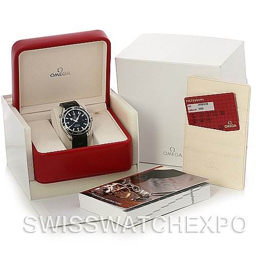 The image shows the Omega Planet Ocean 2900.50.91 Men's Stainless Steel Black Dial 2900.50.91 Men's Stainless Steel Black Dial watch at an angle in its box with accompanying accessories, including a cardholder and booklet.