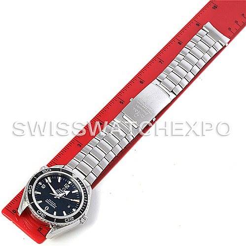 This image shows an Omega Planet Ocean 2200.50 Men's Stainless Steel Black Dial 2200.50 Men's Stainless Steel Black Dial model watch laid flat, displaying the full face, bezel, bracelet, and clasp on a red ruler.