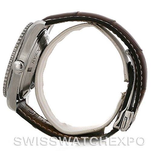 The image shows a side view of an Omega Planet Ocean 2908.50.91 Men's Stainless Steel Black Dial 2908.50.91 Men's Stainless Steel Black Dial watch, highlighting the case, crown, bezel, and leather strap with buckle.