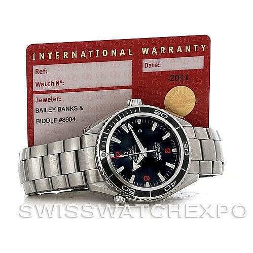 The image shows a Planet Ocean model by Omega viewed from the front along with its international warranty card.
