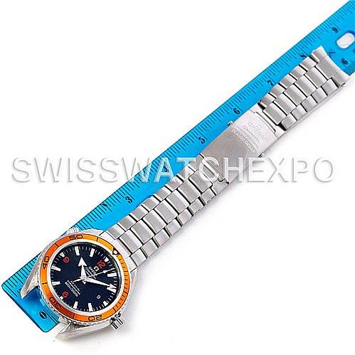 The Omega Planet Ocean 2208.50.00 Men's Stainless Steel Black Dial 2208.50.00 Men's Stainless Steel Black Dial watch is shown from an overhead perspective, displaying its face, bezel, and entire metal bracelet alongside a blue ruler.