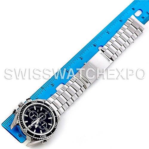 The image shows an Omega Planet Ocean 2210.50.00 Men
s Stainless Steel Black Dial 2210.50.00 Men
s Stainless Steel Black Dial watch, displayed fully with a metal bracelet and a blue ruler for scale.