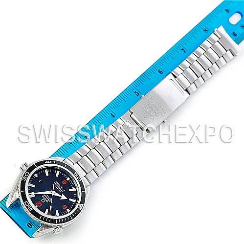 The image shows an Omega Planet Ocean 2200.51.00 Men's Stainless Steel Black Dial 2200.51.00 Men's Stainless Steel Black Dial watch with its full bracelet and clasp, positioned next to a blue ruler for scale.