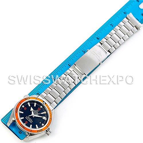 The image shows an Omega Planet Ocean 2209.50.00 Men
s Stainless Steel Black Dial 2209.50.00 Men
s Stainless Steel Black Dial watch laid flat next to a blue ruler, displaying the face, bezel, and full stainless steel bracelet.