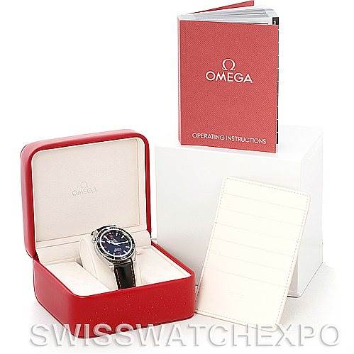 The image shows the Omega Planet Ocean 2900.51.82 Men's Stainless Steel Black Dial 2900.51.82 Men's Stainless Steel Black Dial watch in its red case, accompanied by a manual and paperwork, viewed from a front angle.