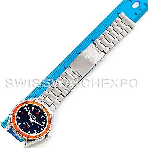 The Omega Planet Ocean 2208.50.00 Men's Stainless Steel Black Dial 2208.50.00 Men's Stainless Steel Black Dial watch is shown from a top-down angle, displaying the full bracelet, clasp, and face alongside a blue ruler.