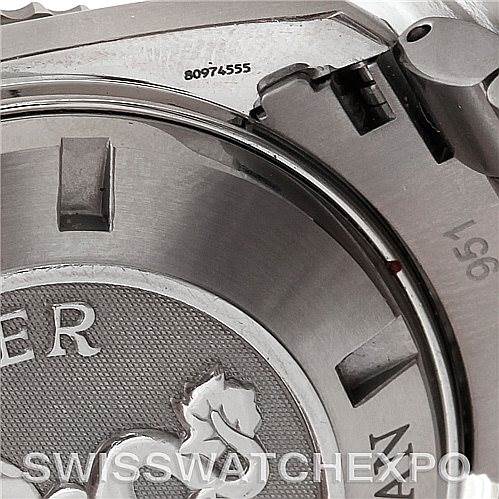 The image shows a close-up of the side and back of an Omega Planet Ocean 2208.50.00 Men's Stainless Steel Black Dial 2208.50.00 Men's Stainless Steel Black Dial watch, highlighting the serial number and part of the case back.