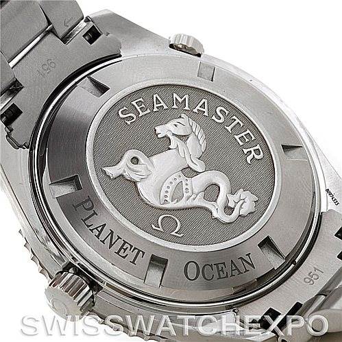 The image shows the case back of the Omega Seamaster Planet Ocean watch, displaying its engraved seahorse emblem and branding.