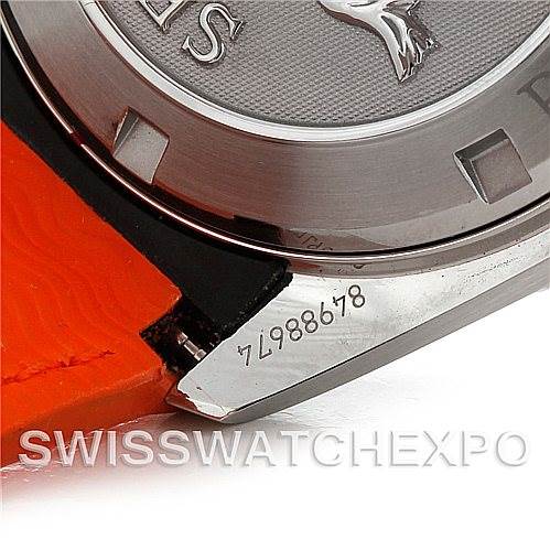The image shows a close-up of the serial number and case back of the Omega Planet Ocean 2909.50.83 Men
s Stainless Steel Black Dial 2909.50.83 Men
s Stainless Steel Black Dial watch, along with part of an orange strap.