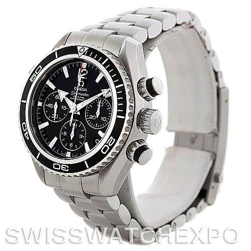 The image shows an Omega Planet Ocean 22230385001001 Stainless Steel Black Dial 22230385001001 Stainless Steel Black Dial watch at a three-quarter angle, displaying the face, bezel, crown, pushers, and metal bracelet.