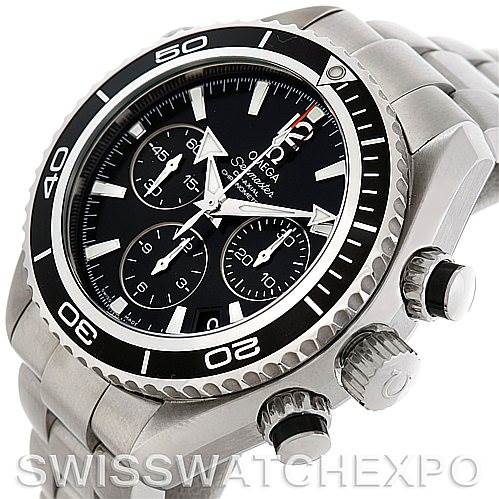 The image shows an angled view of the Omega Planet Ocean 22230385001001 Stainless Steel Black Dial 22230385001001 Stainless Steel Black Dial watch, highlighting the dial, bezel, and crown, with part of the bracelet visible.